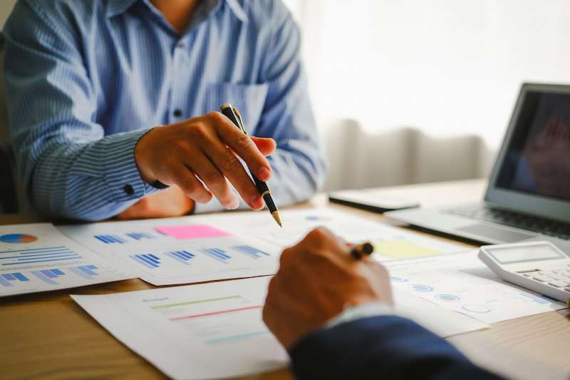 Consultant reviewing business valuation reports with client
